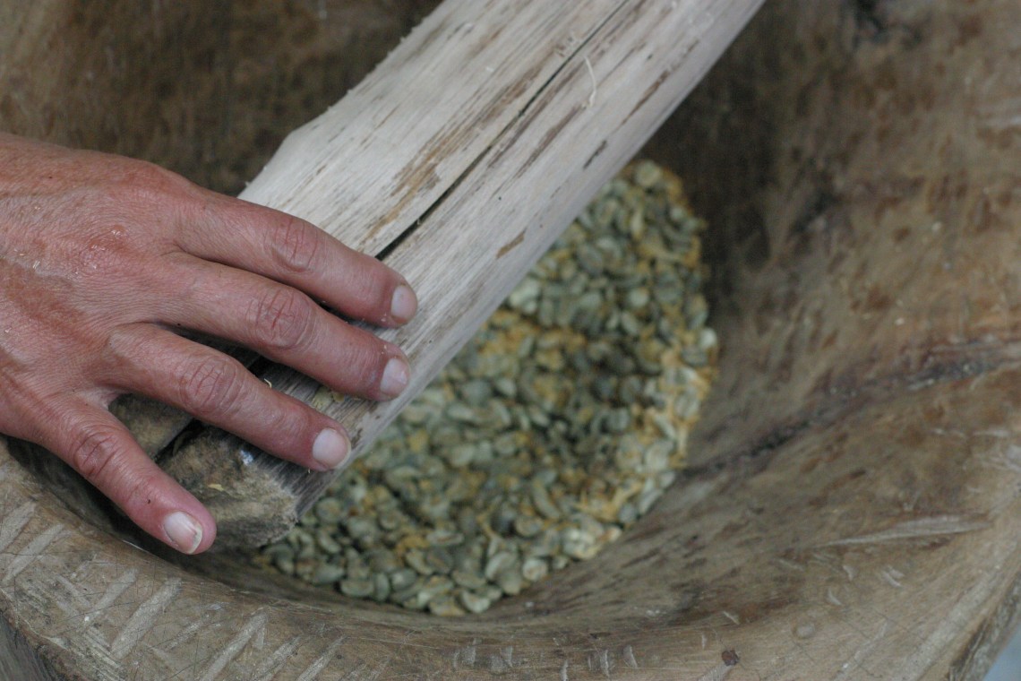 Traditional Colombian coffee hulling by hand at Finca La Pradera in Antioquia